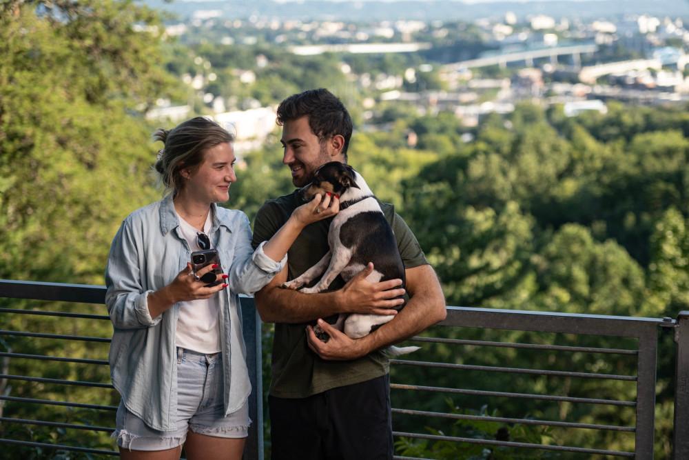 Couple holding dog overlooking Tennessee hills