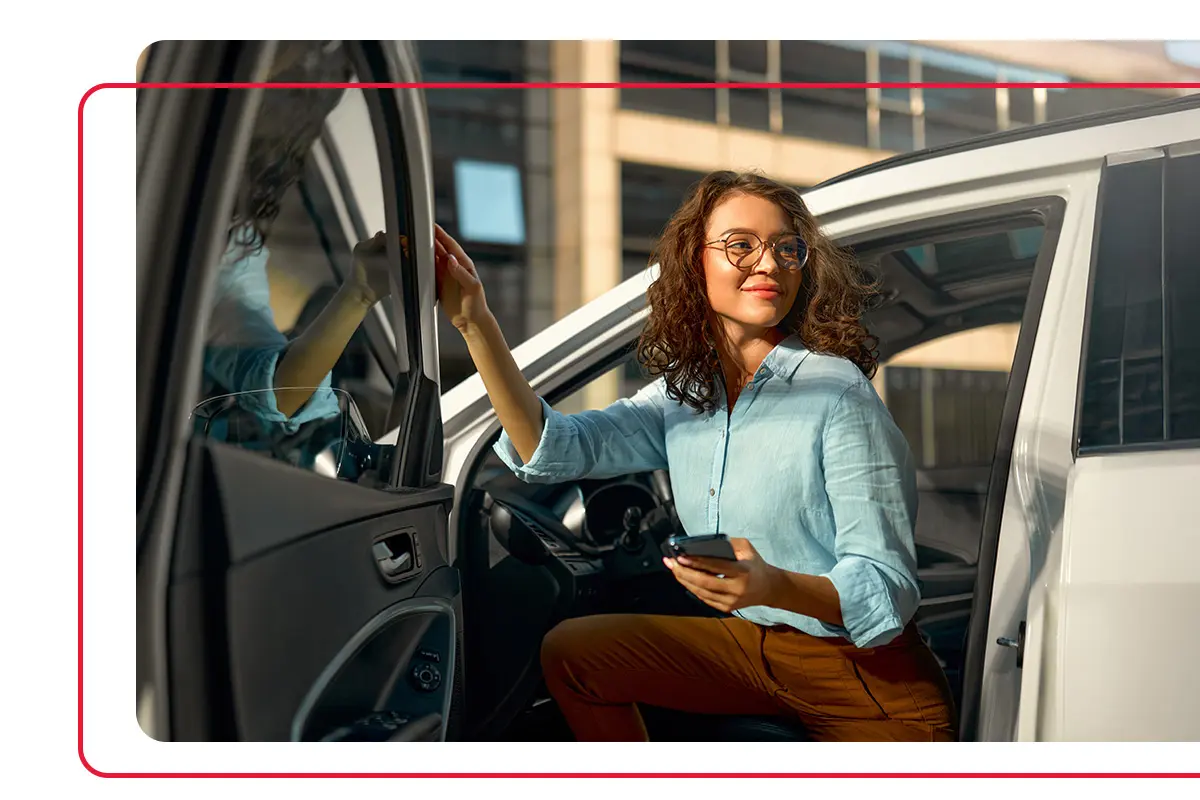Woman with glasses getting out of her car