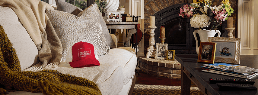 Red Farm Bureau hat sitting on couch in house