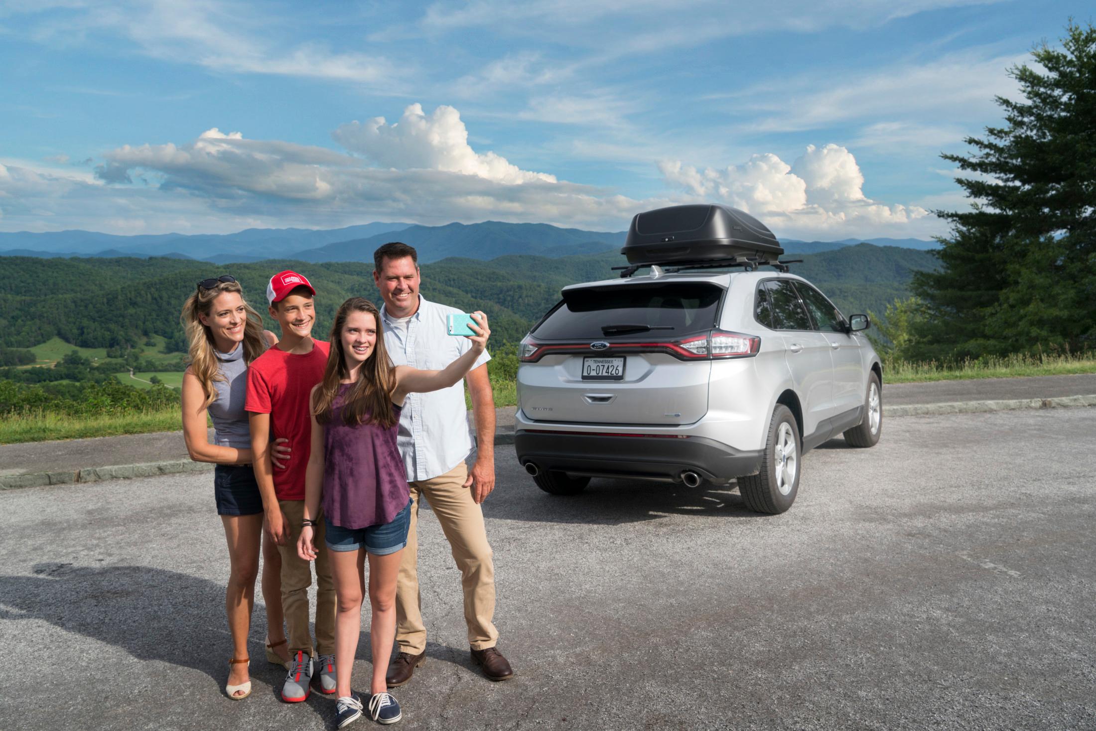 Family taking selfie in Tennessee next to car 
